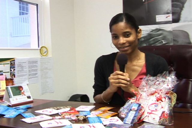 HIV/AIDS Unit Coordinator, Health Promotions Unit in the Ministry of Health on Nevis Mrs. Nadine Carty-Caines with a sample of the “love package” for distribution at the Memorial Square in Charlestown on Valentine’s Day